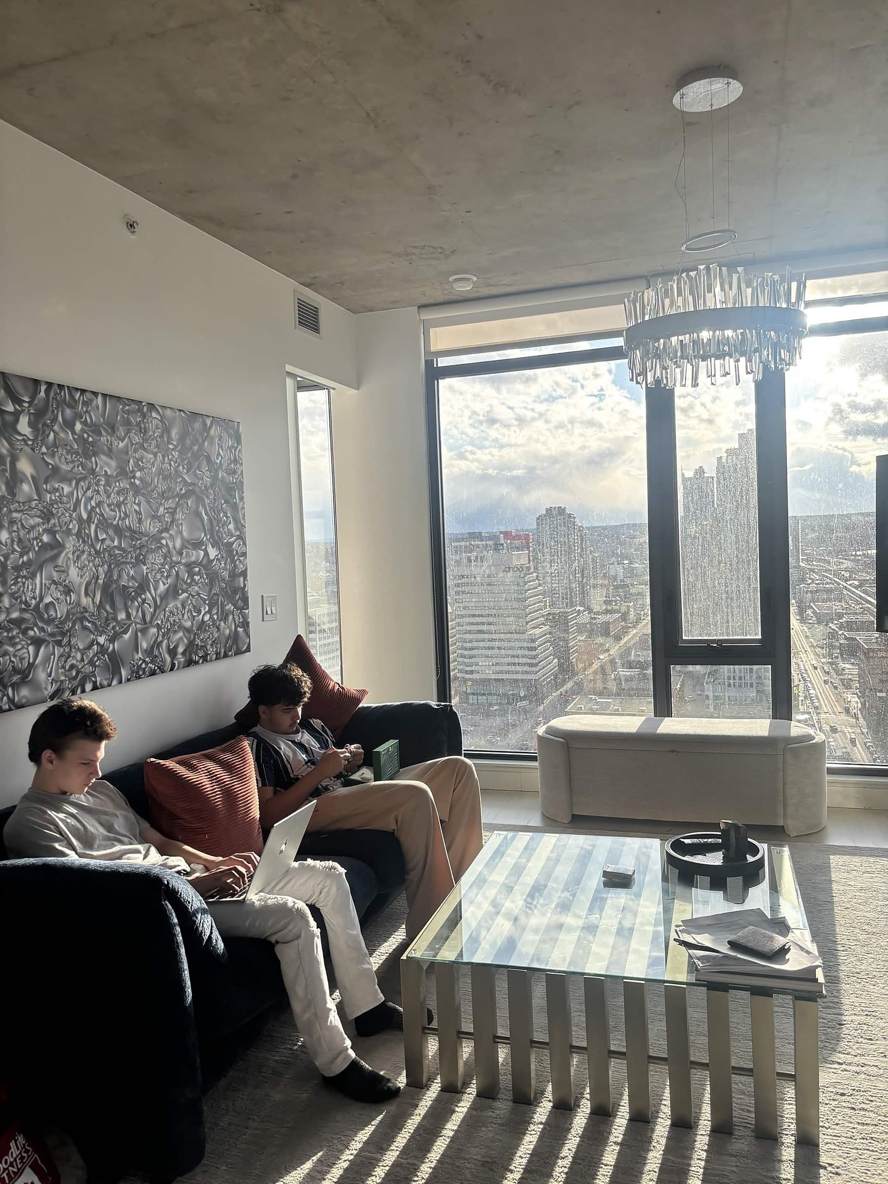 Noa Assaf working from a high-rise apartment overlooking the city